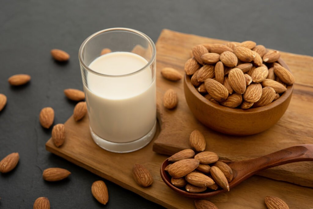 almond milk with almond wooden spoon bowl