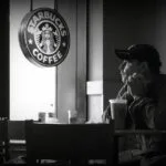 man at starbucks looking out of the window